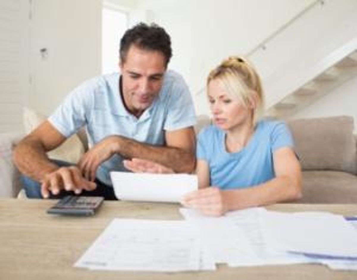 couple with bills and calculator