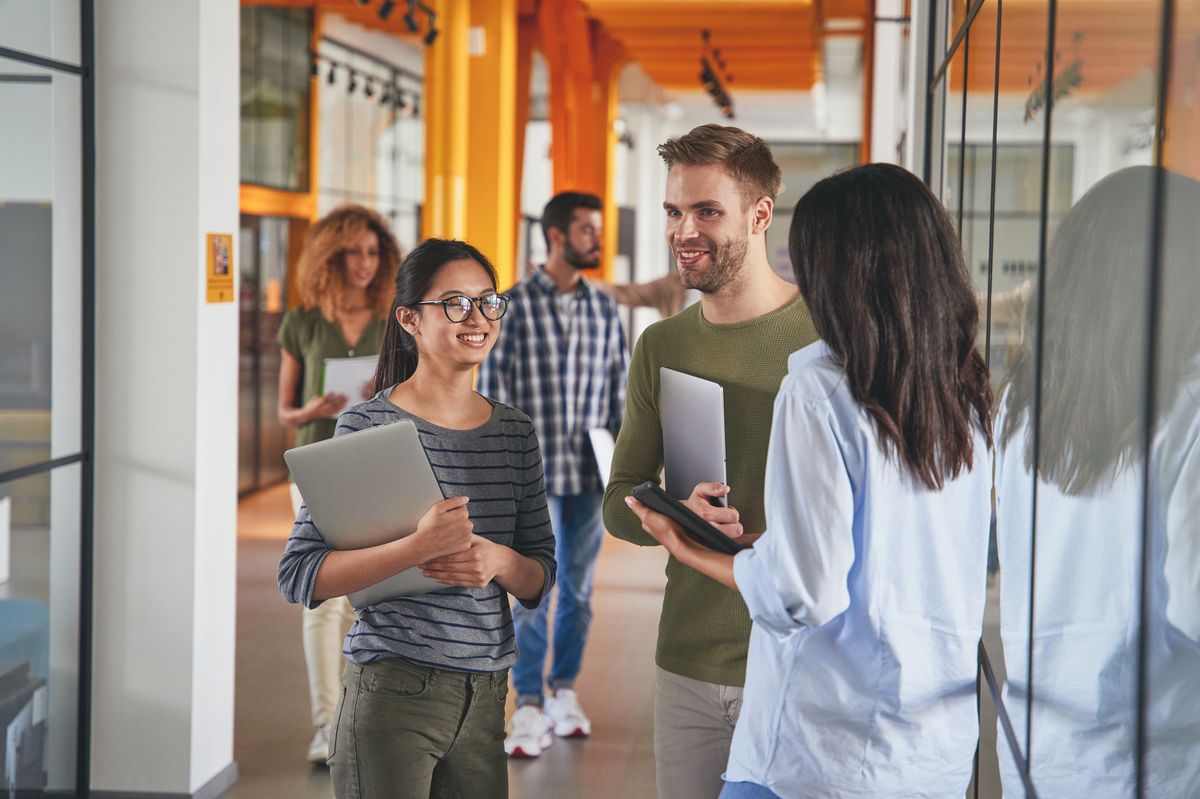 Enthusiastic young people in a 2025 workplace