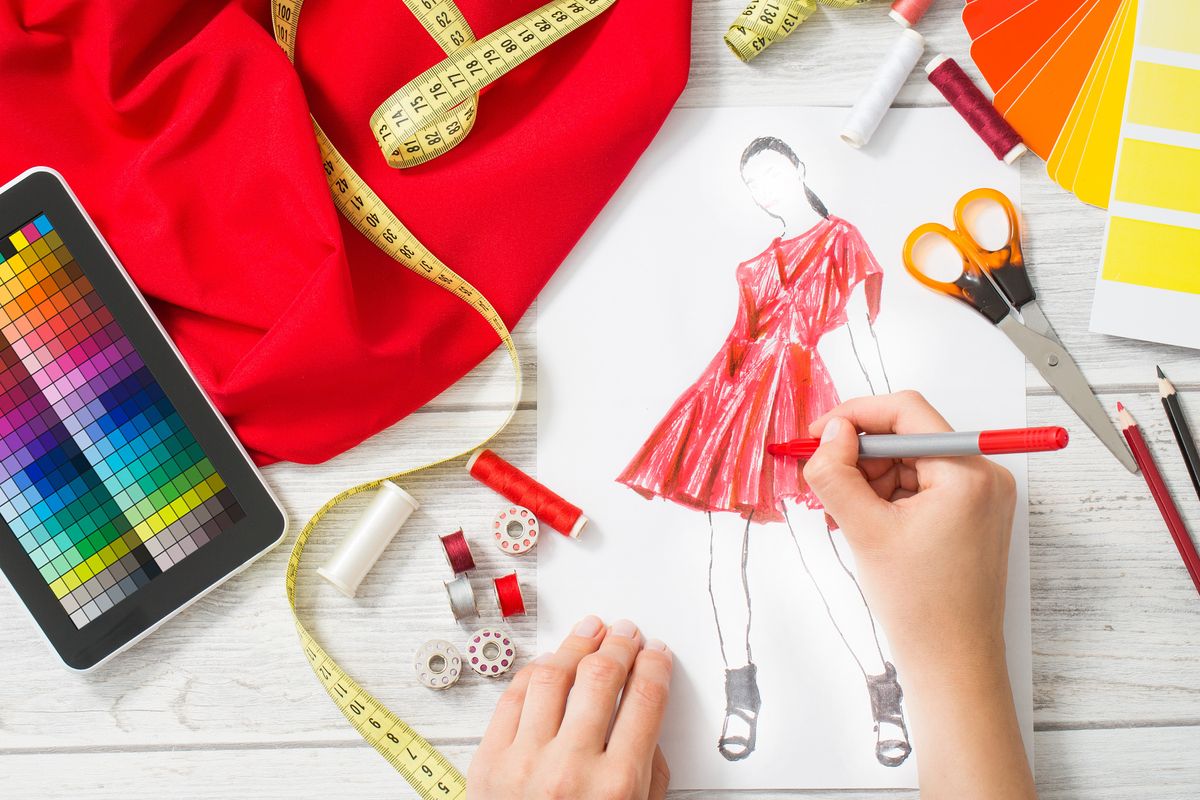 Fashion designer drawing a dress design