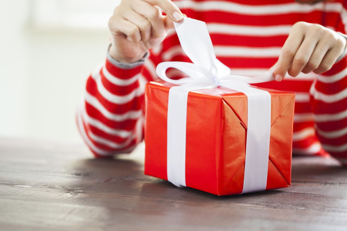 Female hands unpacking gift box