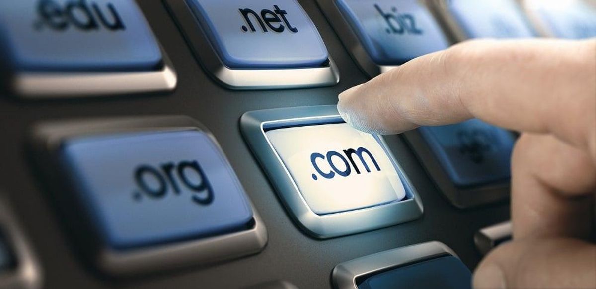 Finger pushing a button on a conceptual dashboard with domain extensions