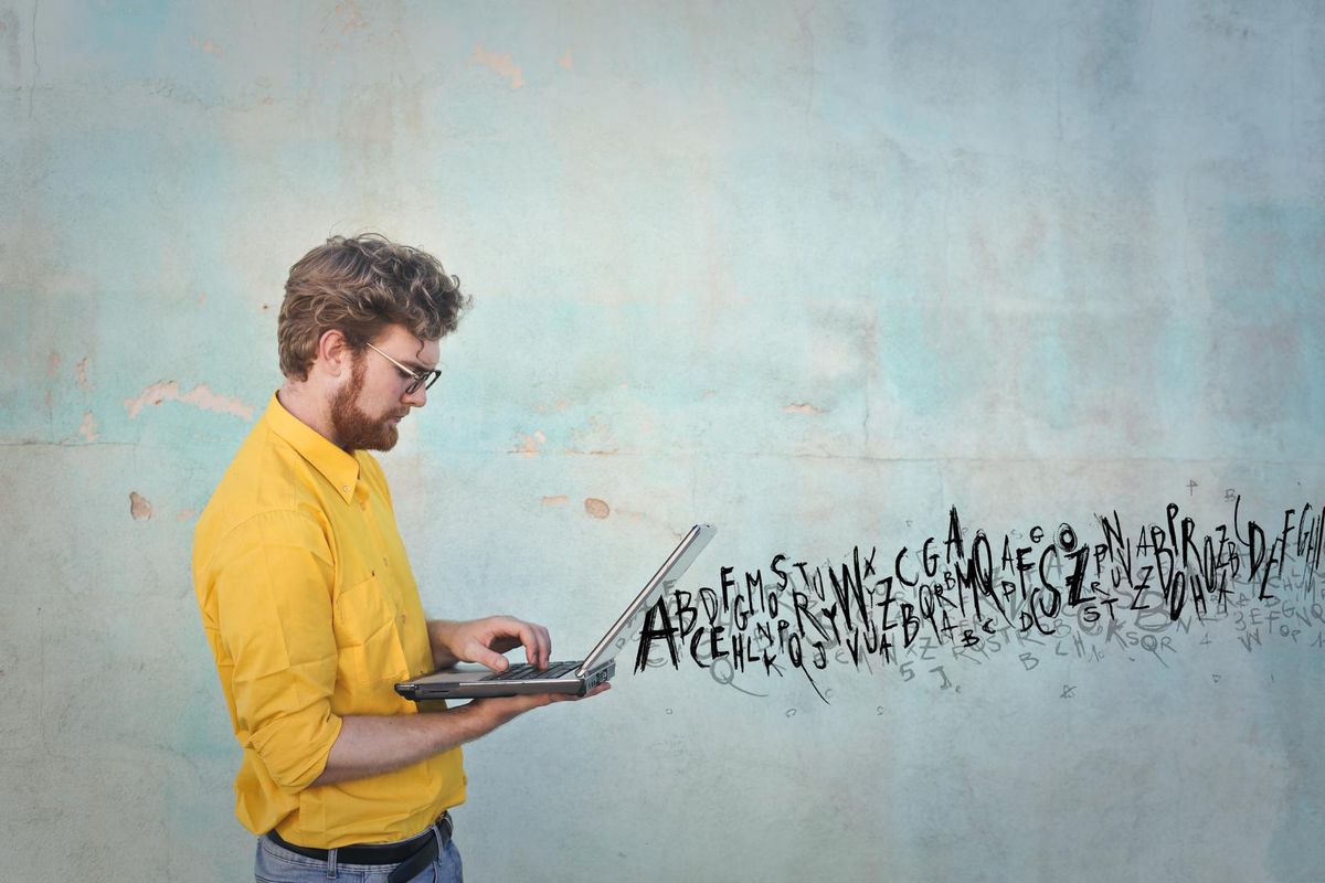 Flowing letters from a man's laptop