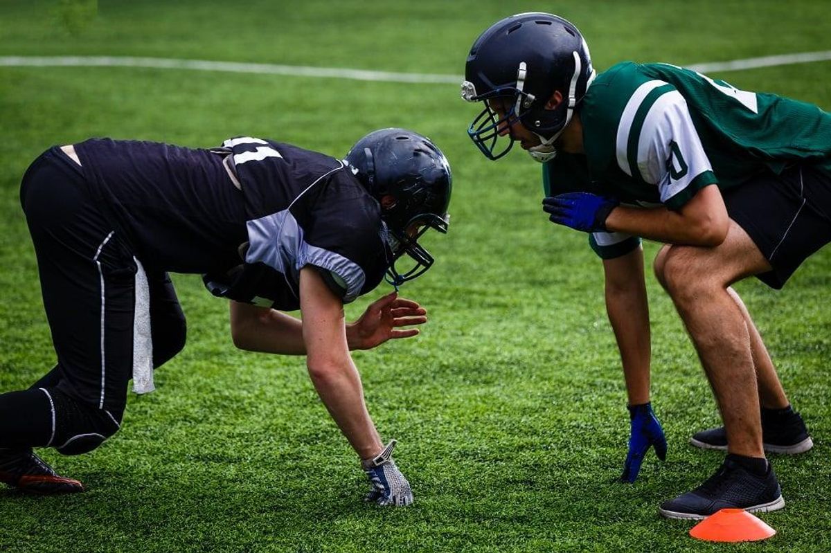 Football players offense defense in action