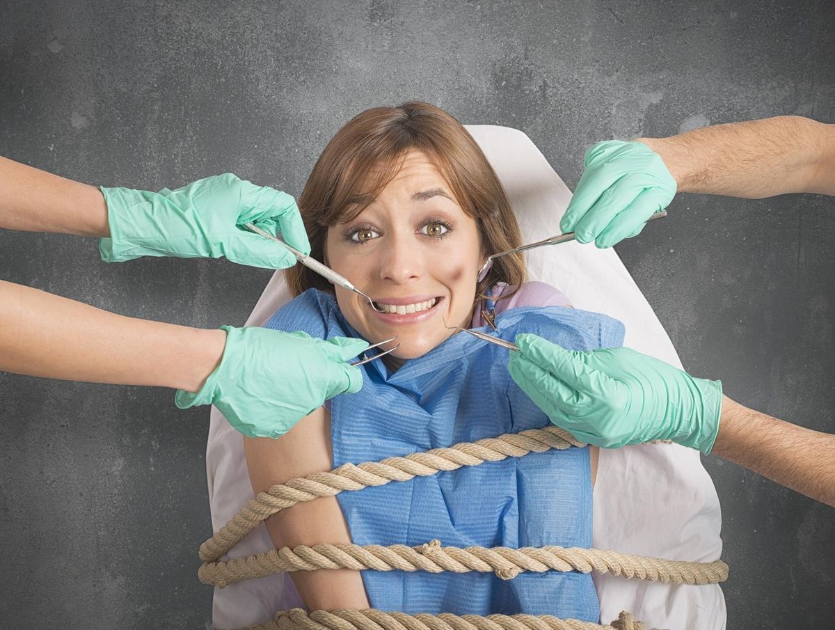 Girl tied to a chair at dentist