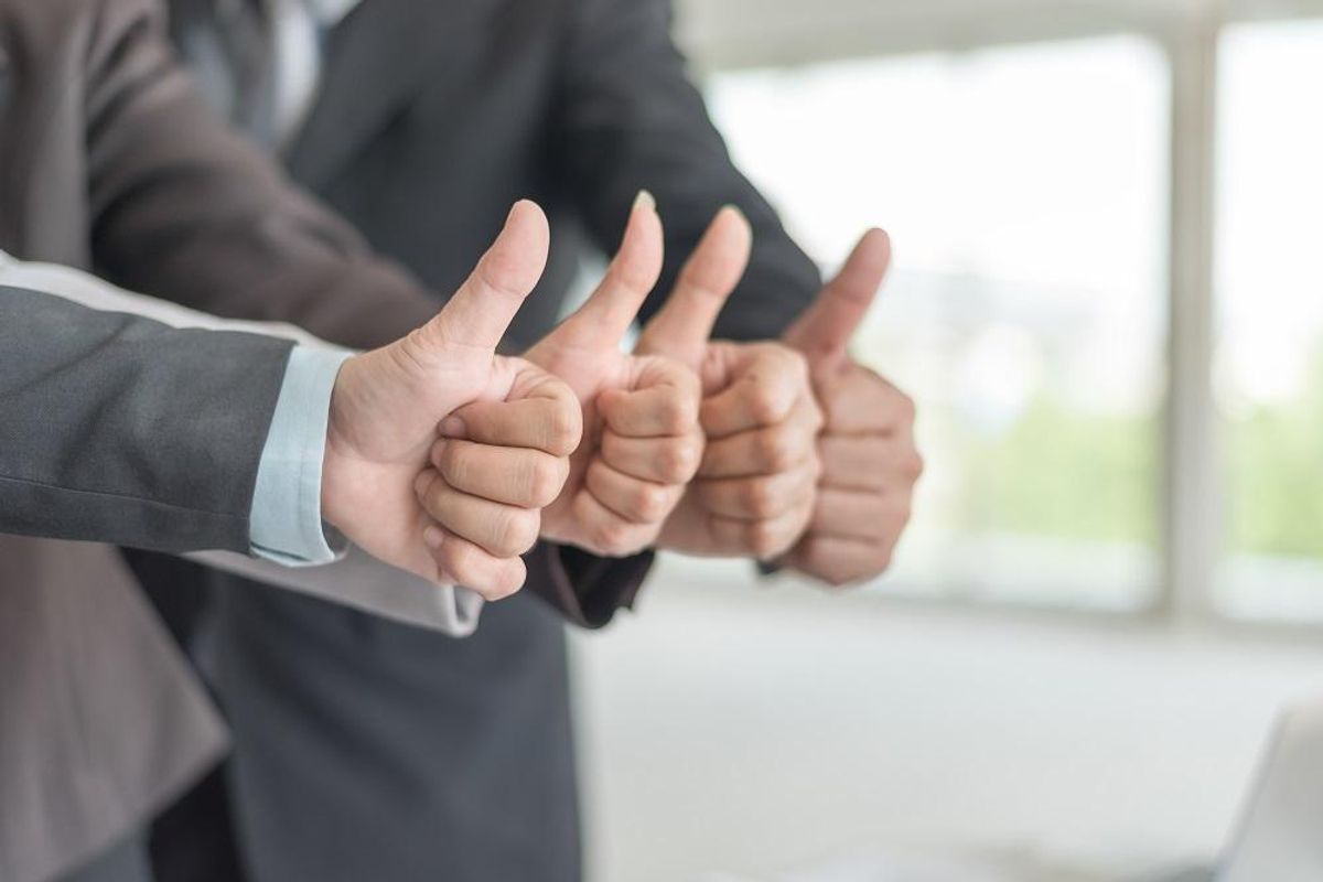 giving thumbs up