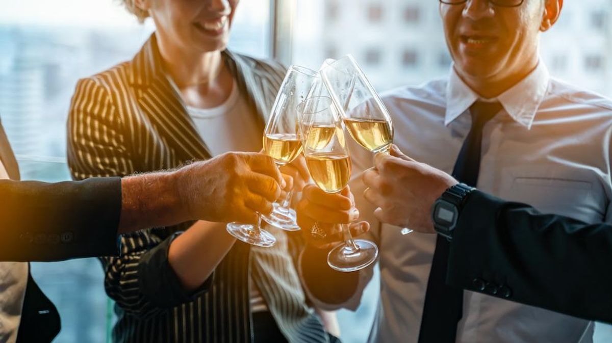 group of coworkers toasting with champagne