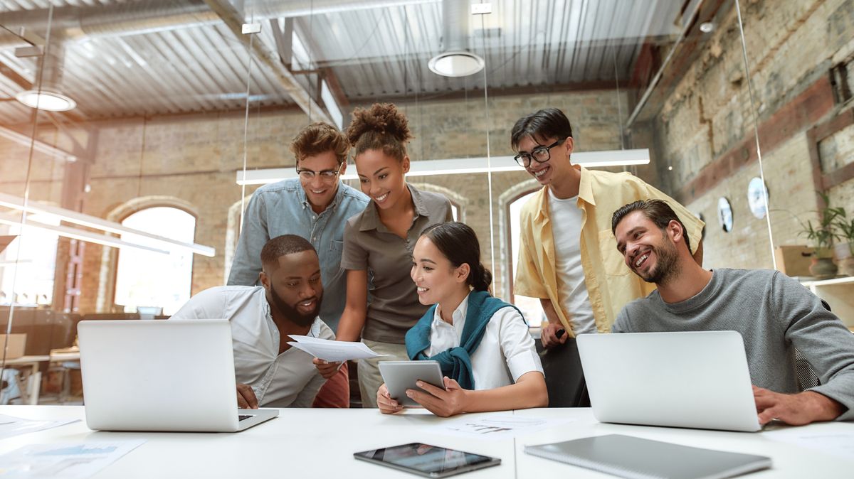 Group of young cheerful Gen Z employees and their manager