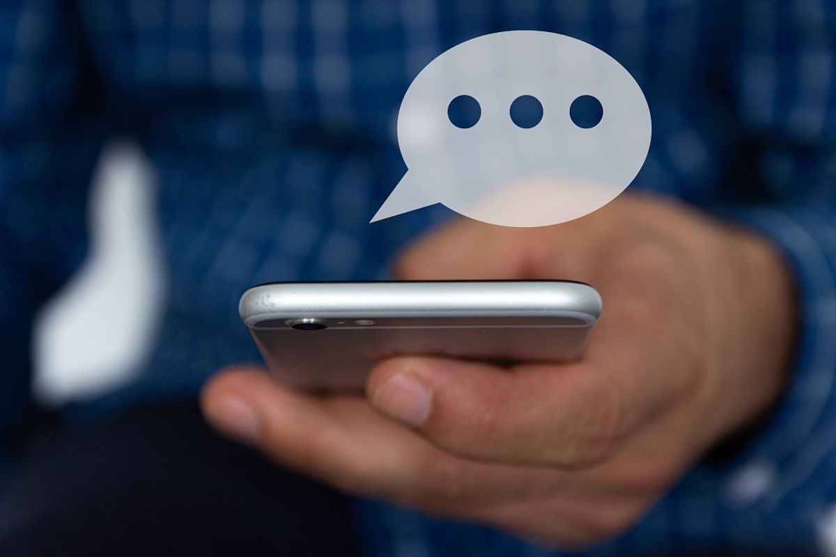 Hand of man typing text on mobile smartphone