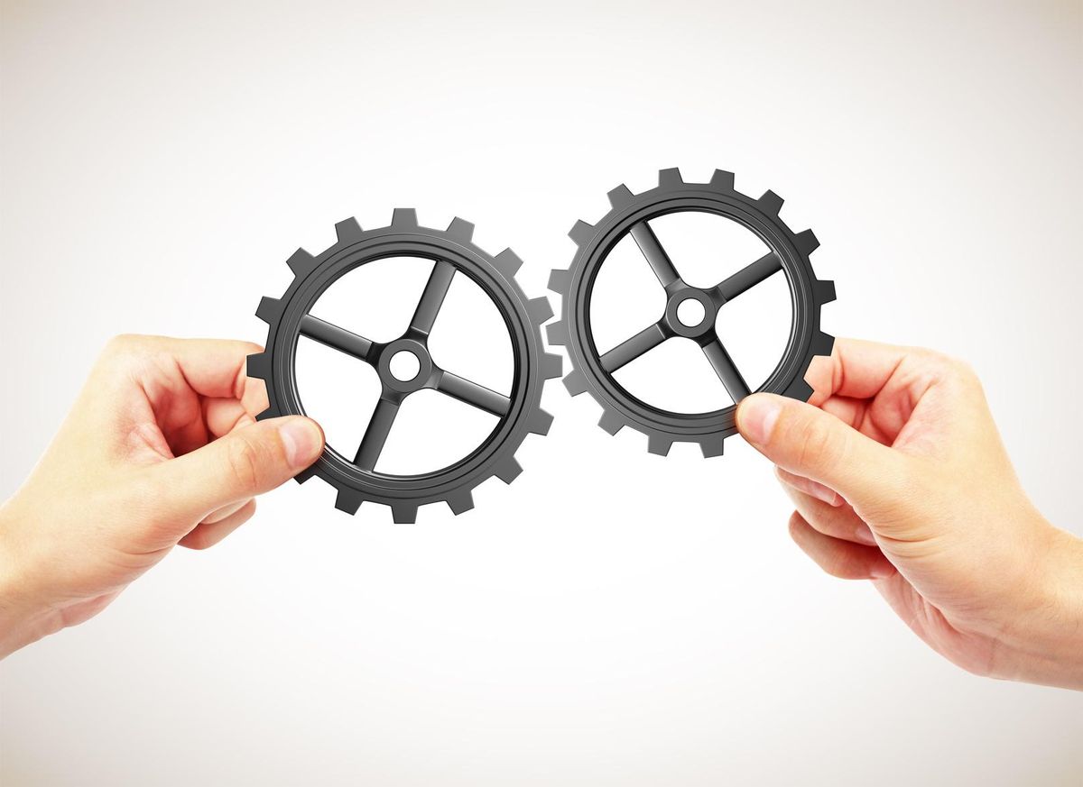 hands holding gears