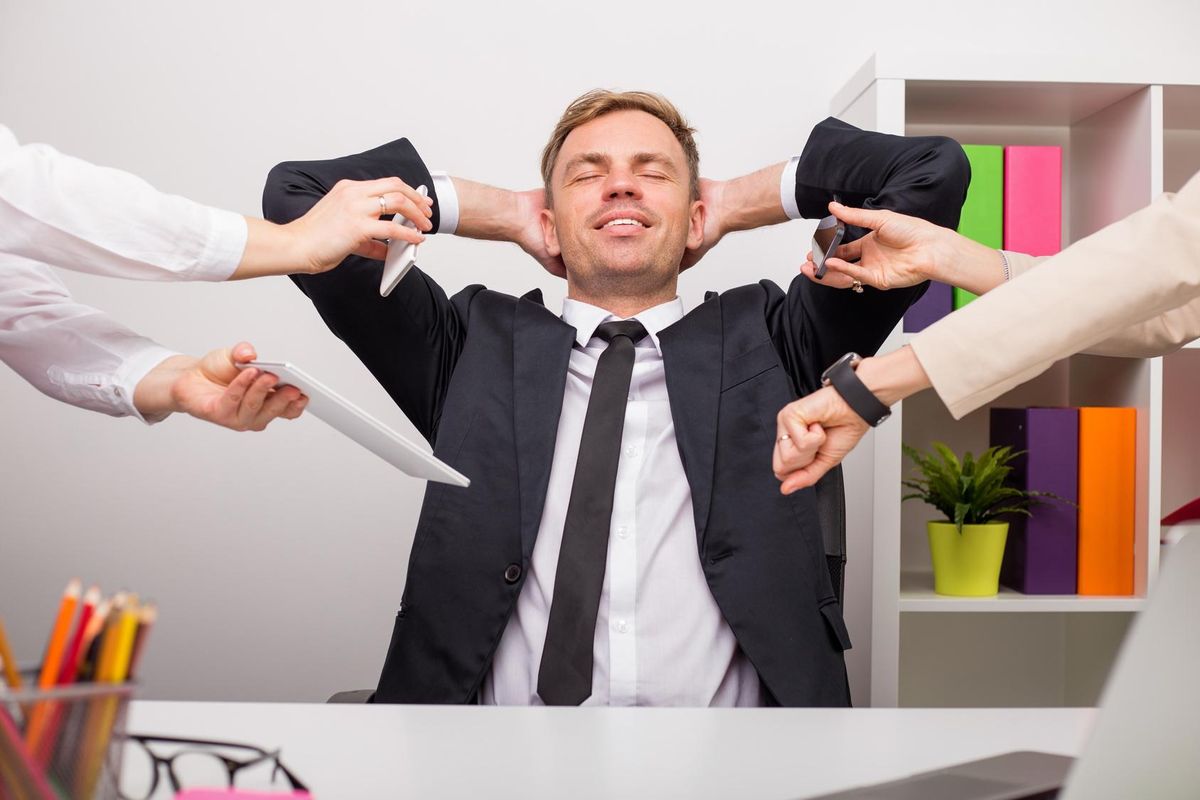 Happy and relaxed man at the office
