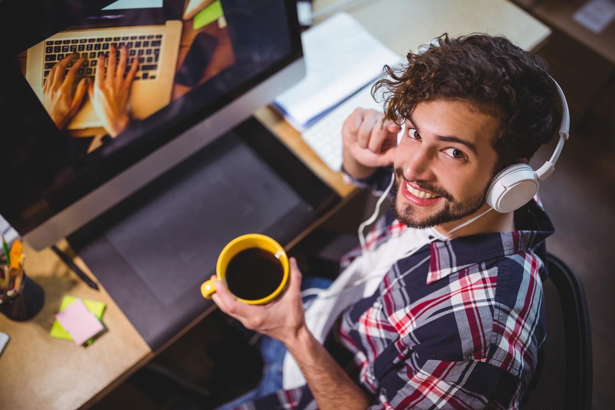 happy creative businessman holding coffee cup