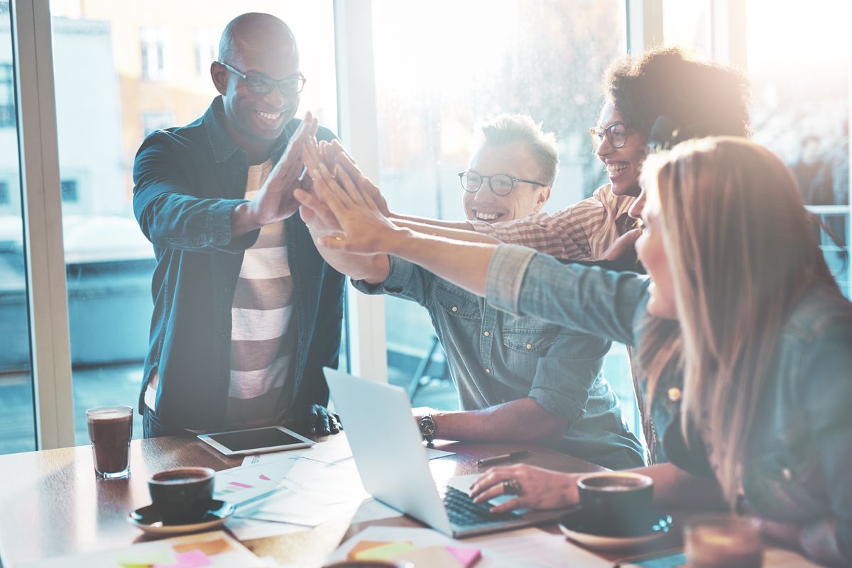 High fiving coworkers during a team-building activity