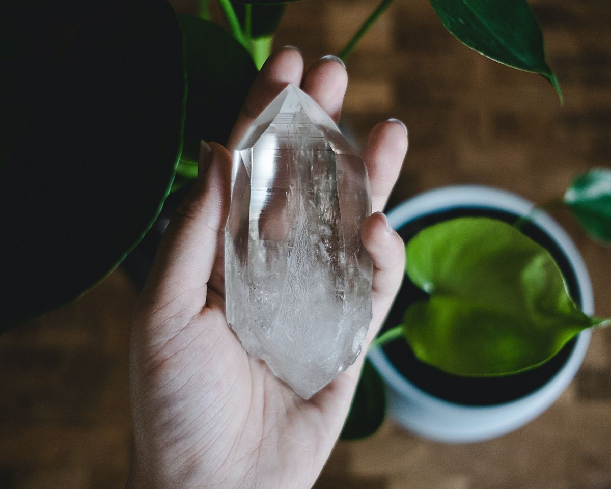 Holding a crystal as part of a spiritual ritual for business