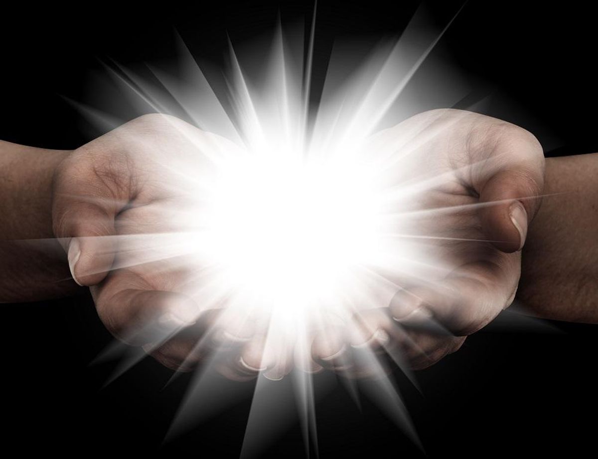 Holding hands open with glowing lights