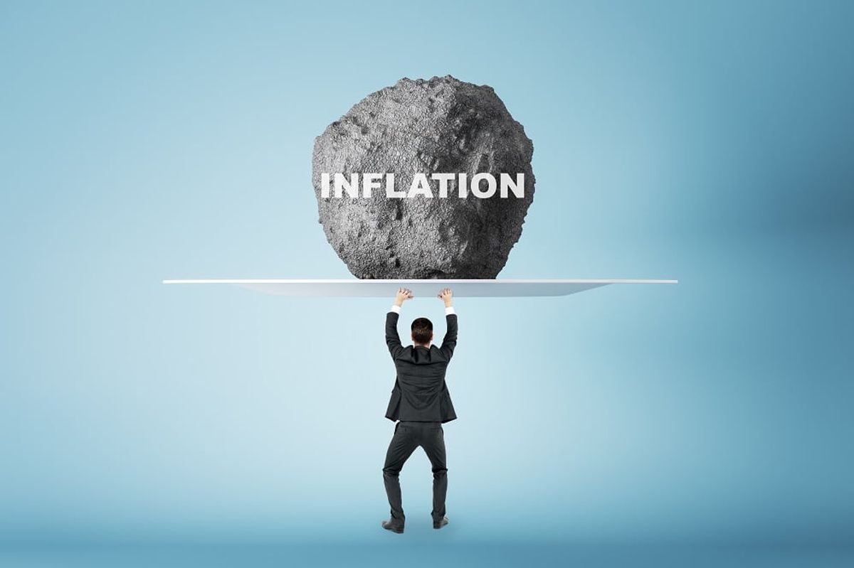 holding huge stone with inflation sign