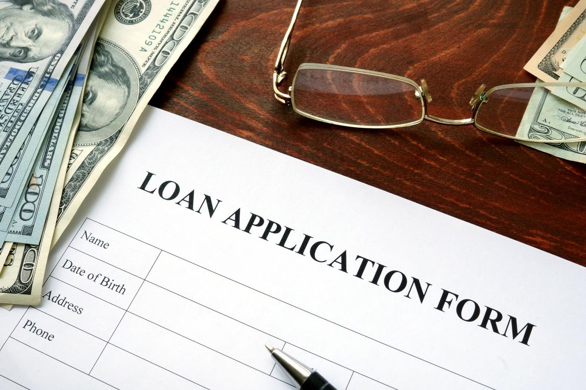 Loan application form on a wooden table.