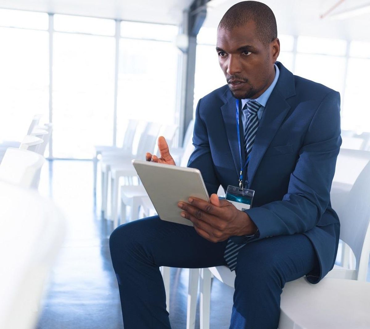 Male speaker practicing his speech on digital tablet