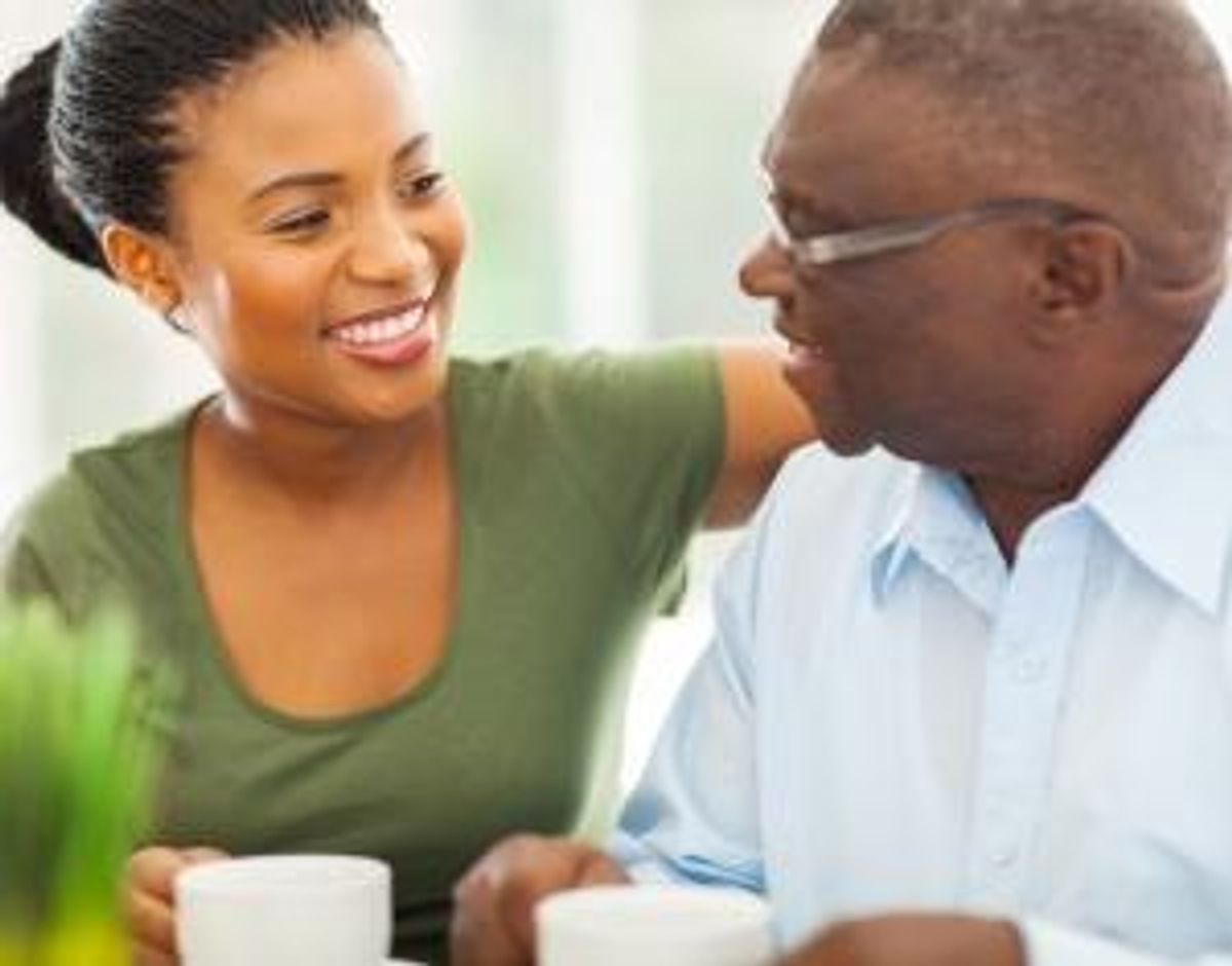 man enjoying coffee with his granddaughter