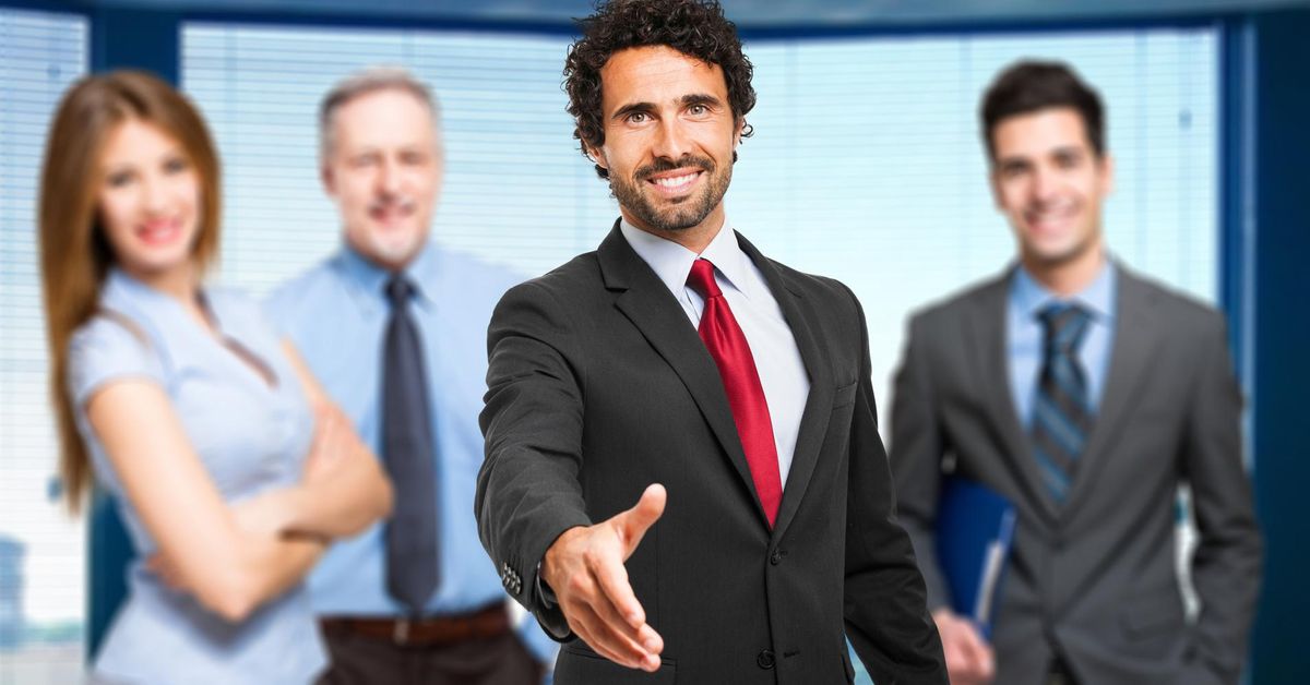 Man from small accounting business offers handshake