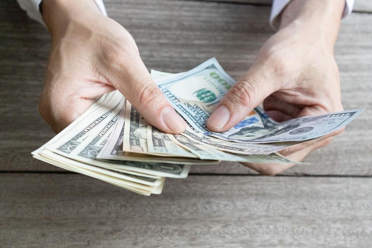 Man holding dollar banknotes