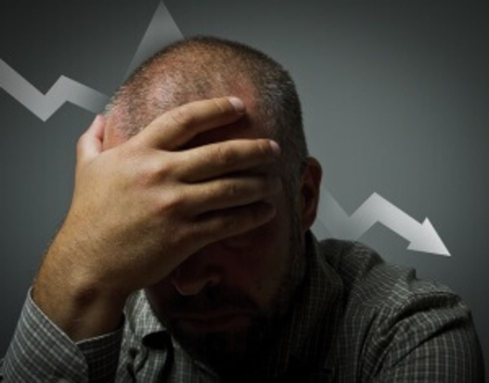 man holding head in hands from failure in starting a business