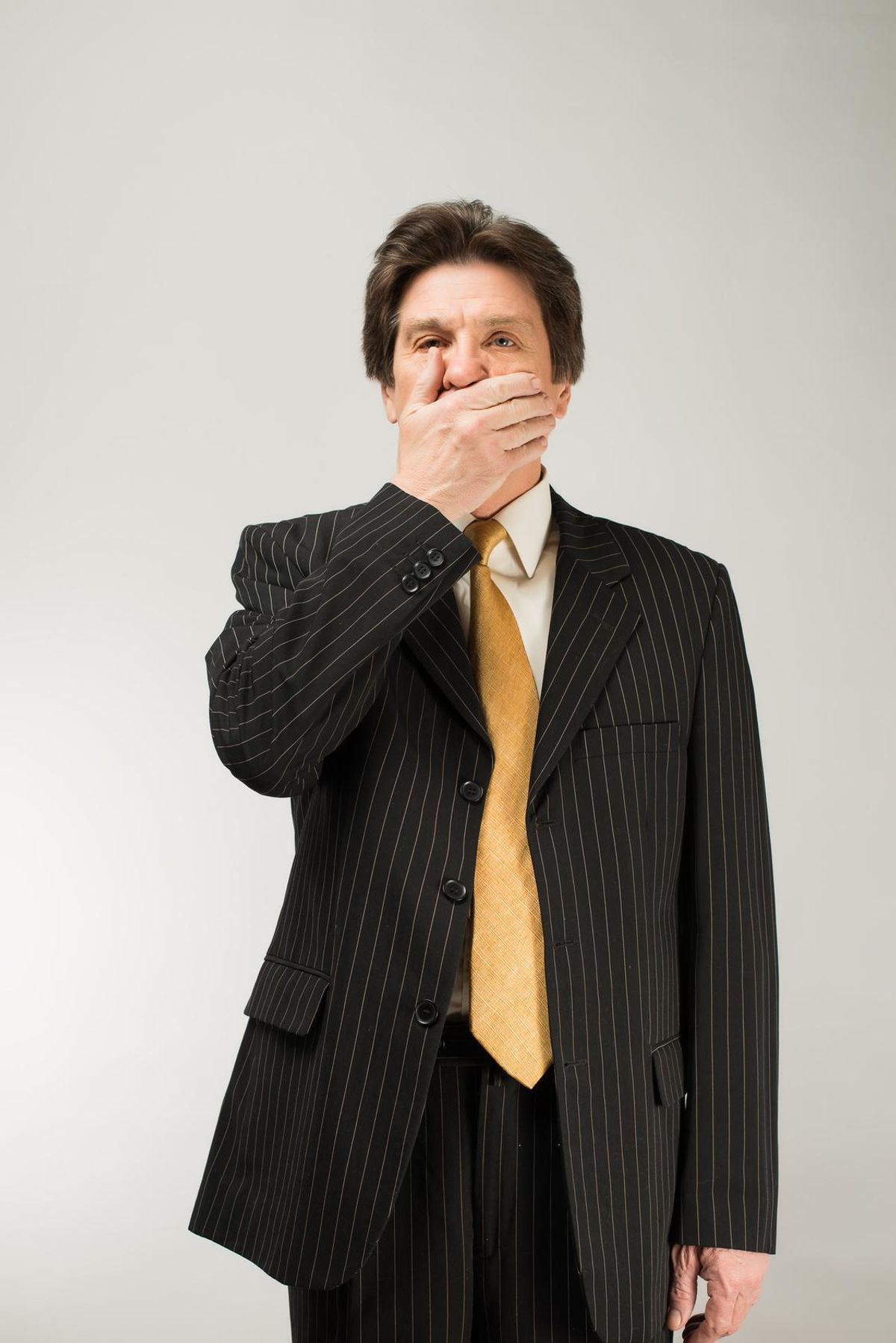 man keep his mouth closed by his hands