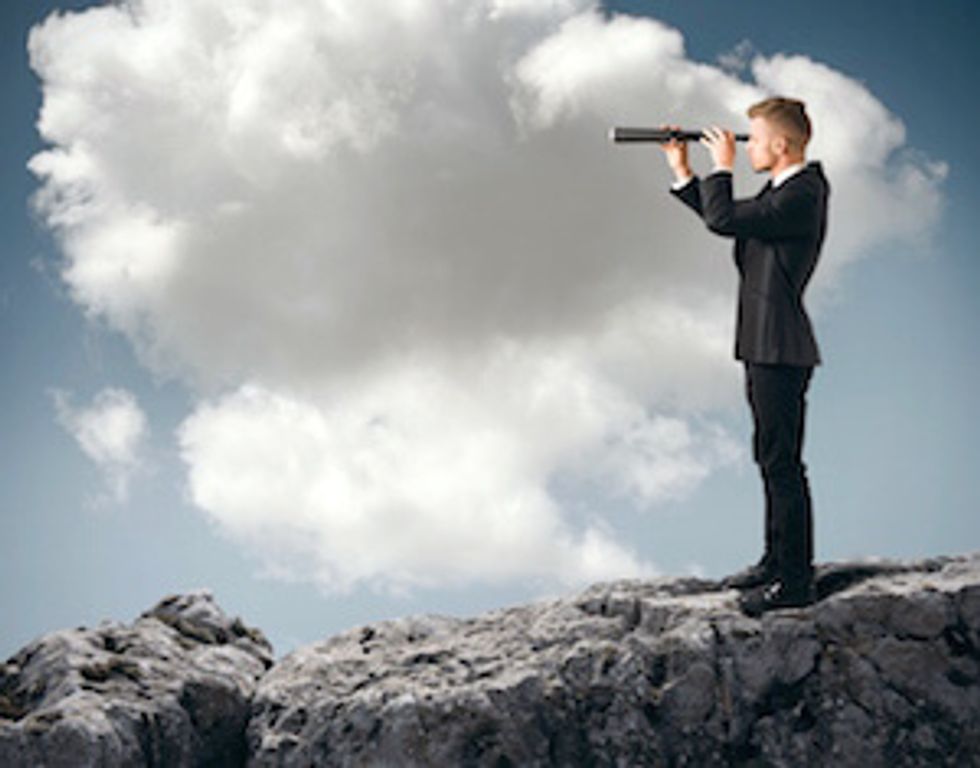 man looking into spyglass symbolizing business predictions for 2015