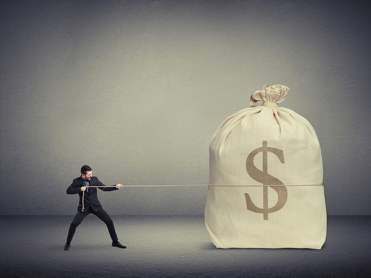 man pulling the rope a big bag of money