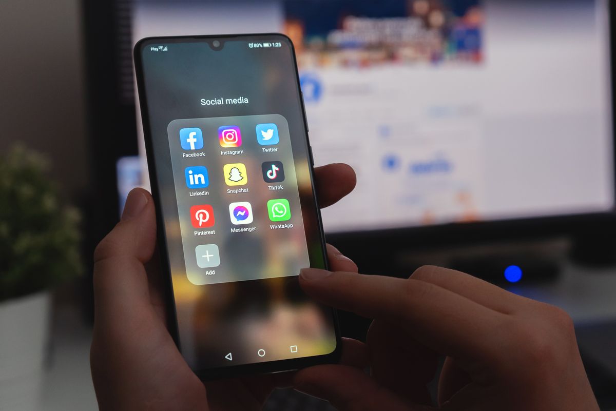 Man trying to choose social media app for small business marketing