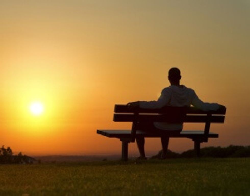 man watching sunset and thinking about future success
