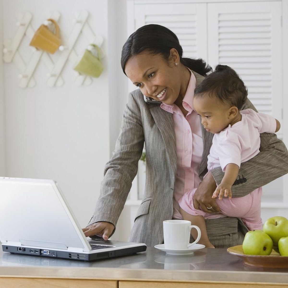 mother working and holding baby