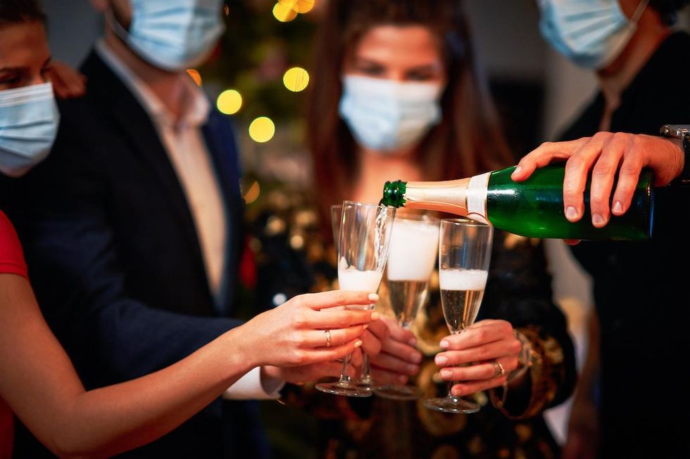 new year's eve party with guests in facemasks