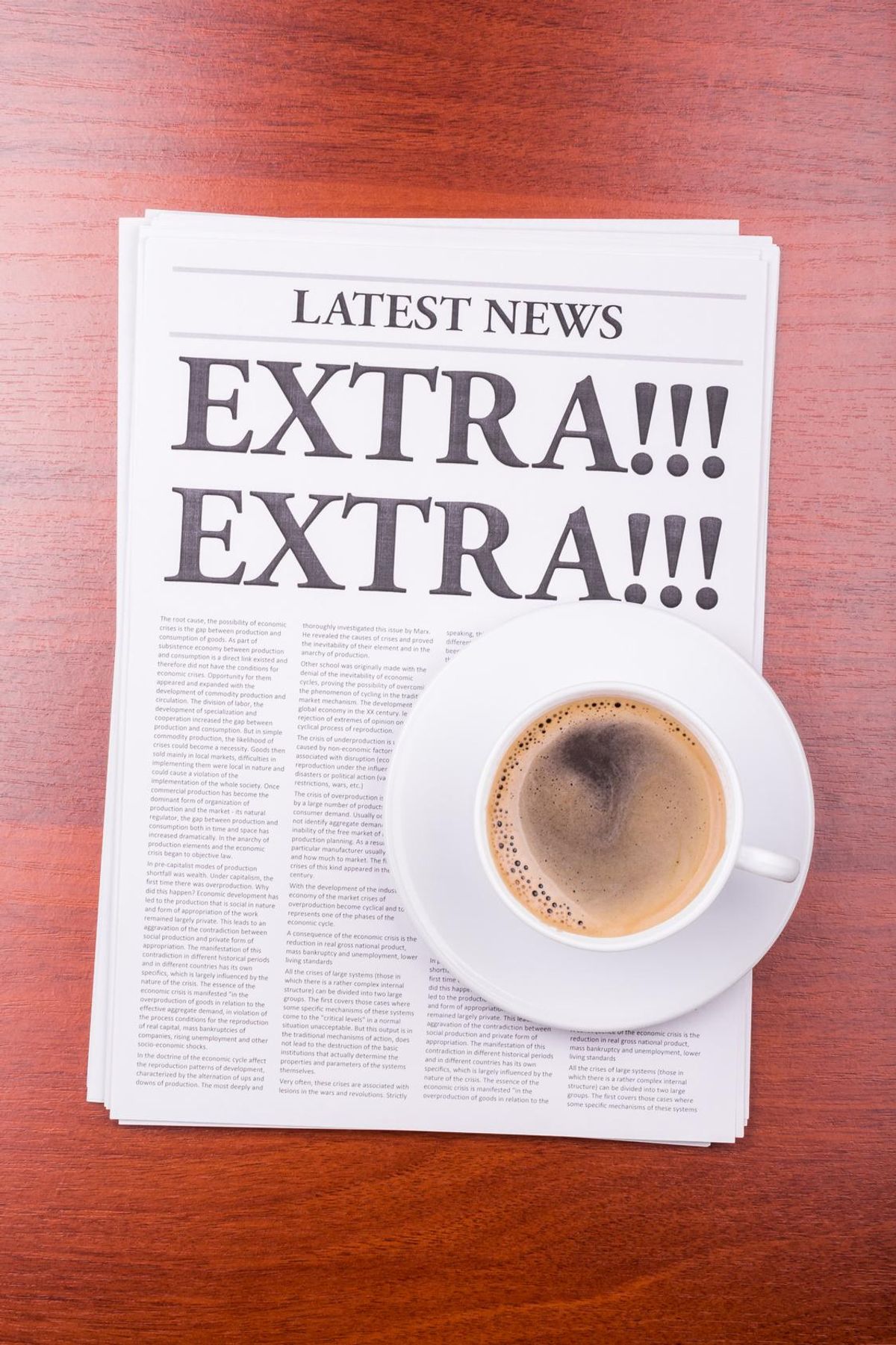 newspaper with the headline EXTRA! EXTRA! and coffee
