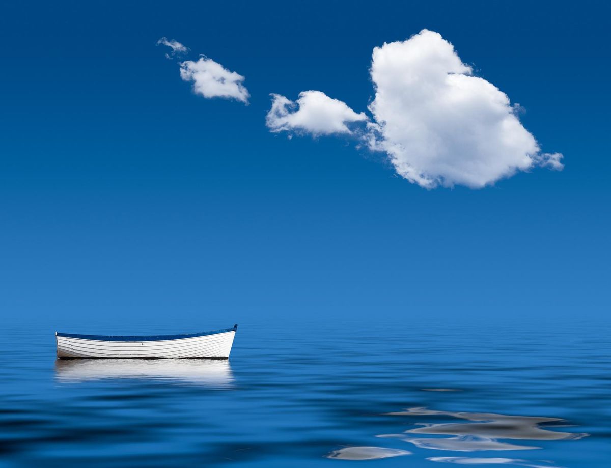 Old rowing boat marooned at sea