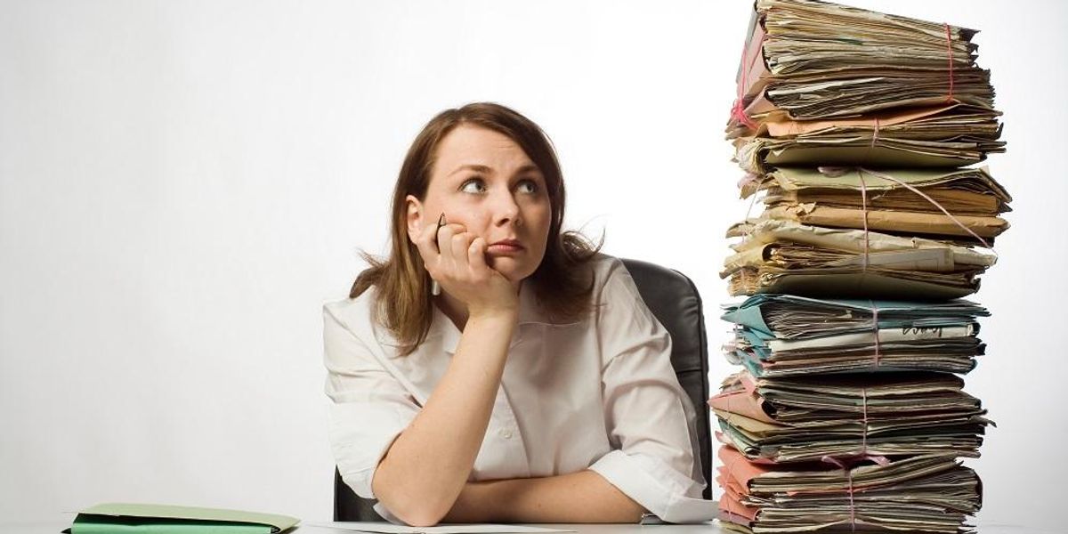 Overwhelmed entrepreneur with paperwork