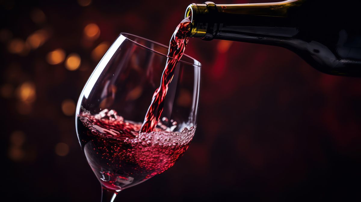 Pouring red wine into a wineglass
