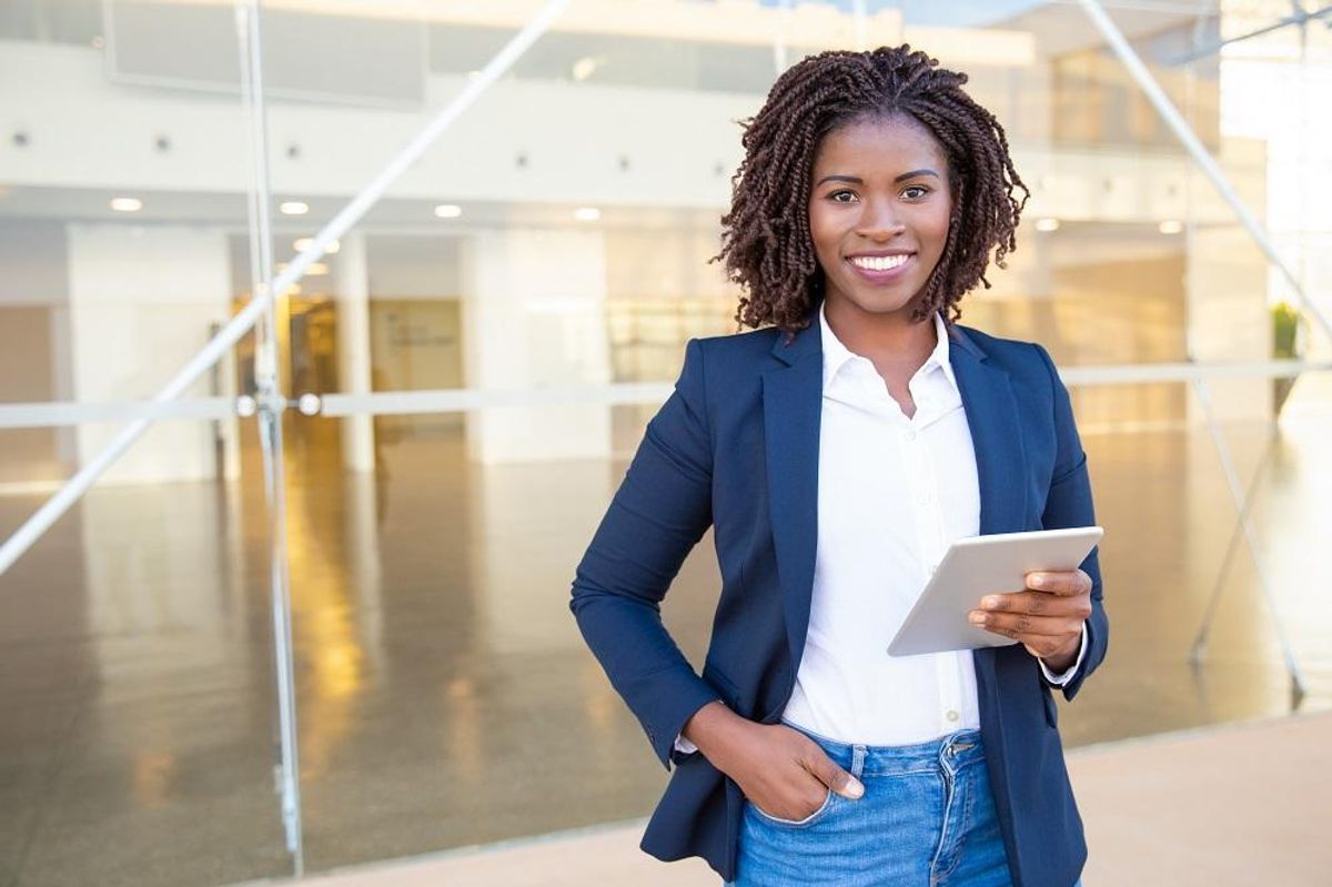 Recent college grad holding tablet