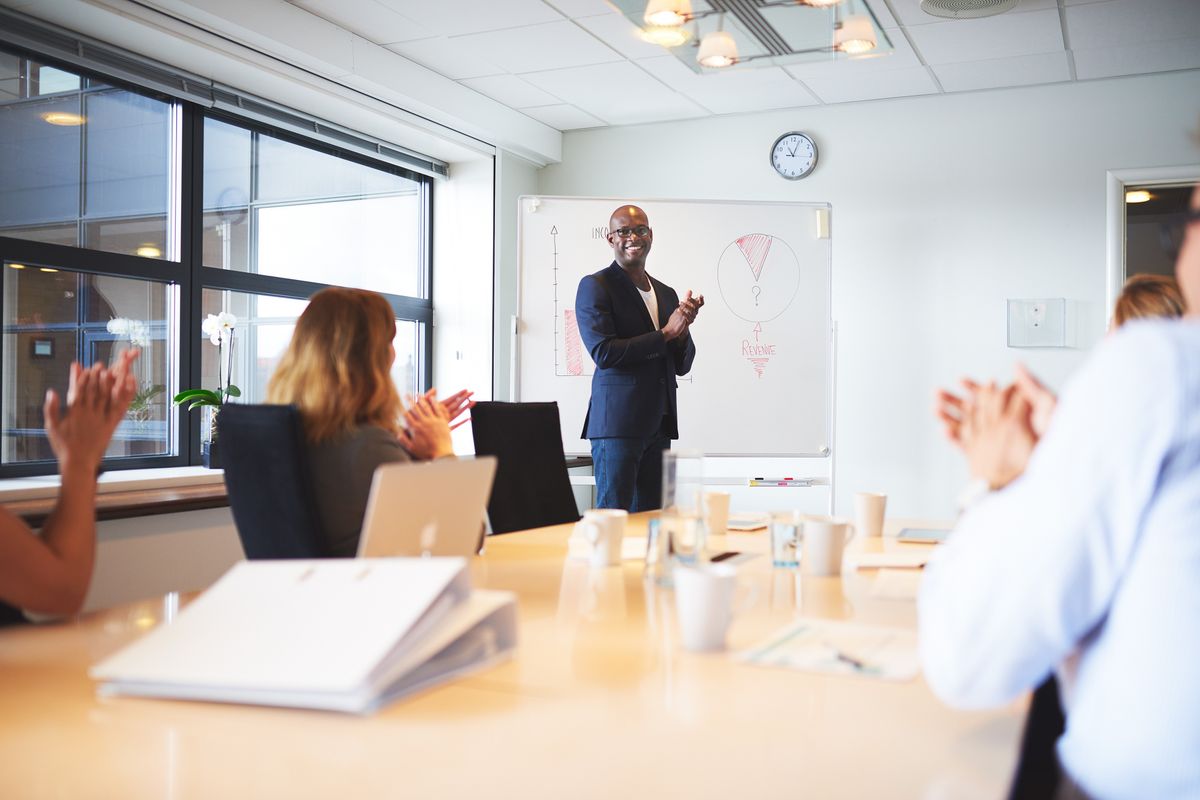 Salesperson talking prospects through the sales funnel