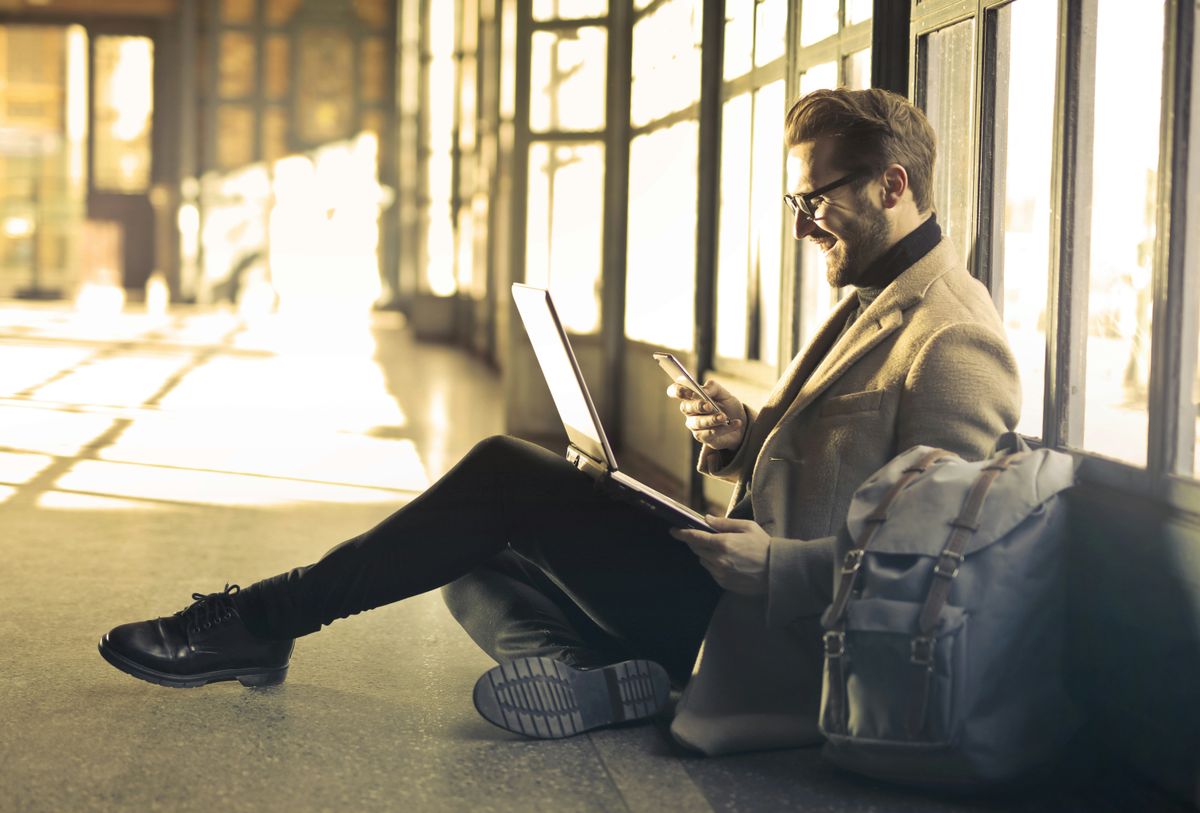 savvy businessman with laptop and phone