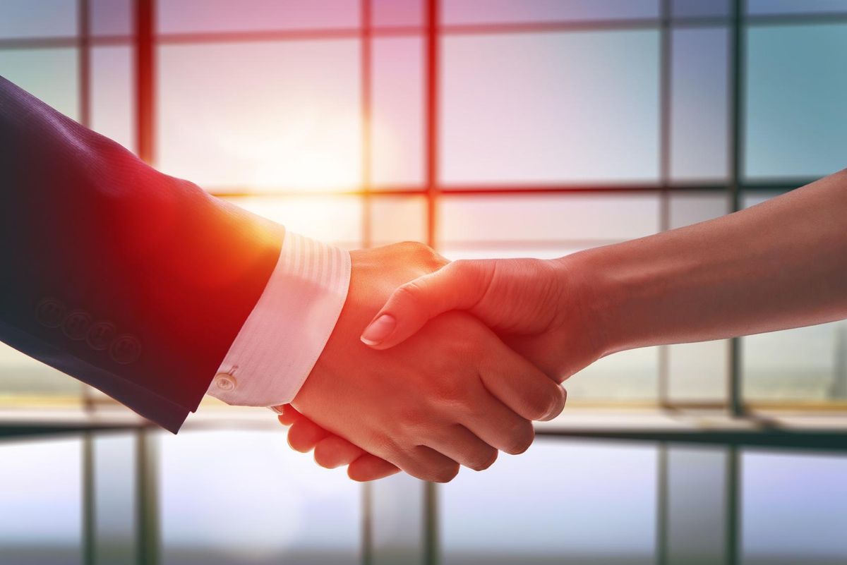 Shaking hands after negotiating Latin American business deal