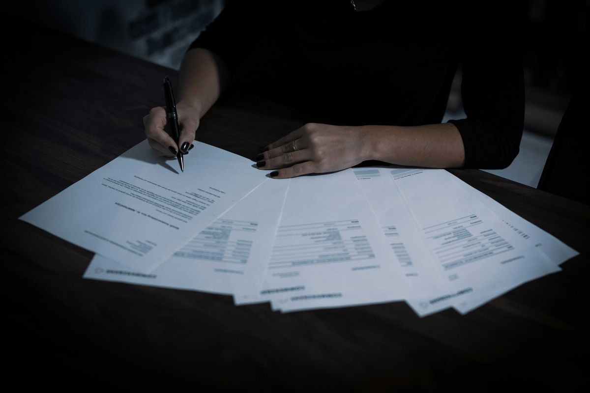 Signing papers to incorporate a business