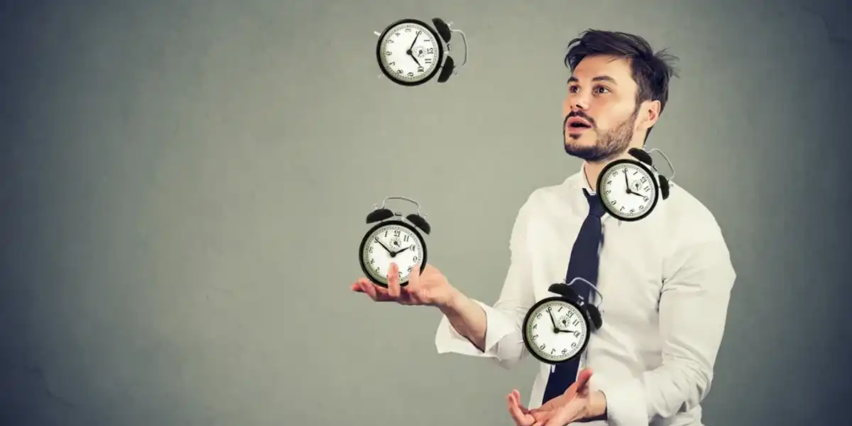 Small business owner juggling clocks representing time management