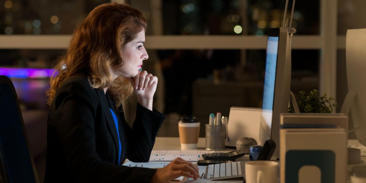 Small business owner working on computer to ensure business survival