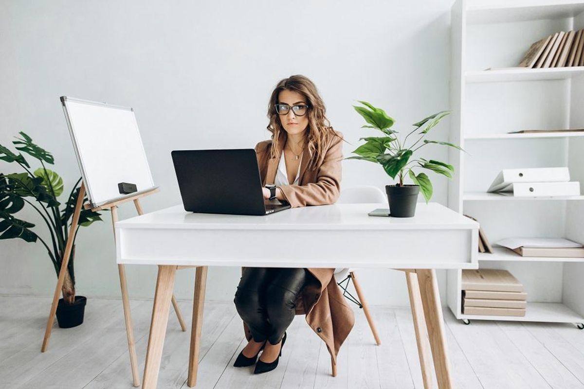 smart girl working on laptop at her workplace in office