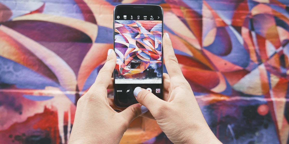 Taking a photo of graffiti for a social media influencer account