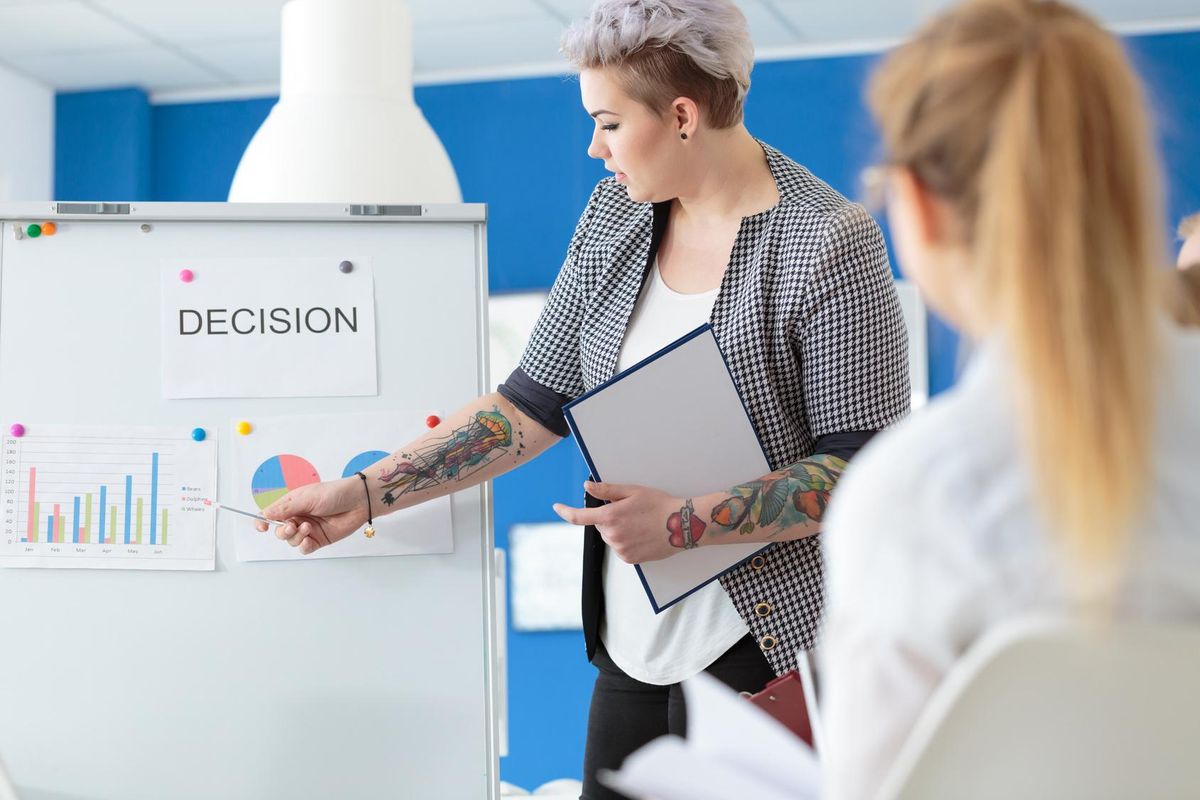 tattooed employee introducing statistics