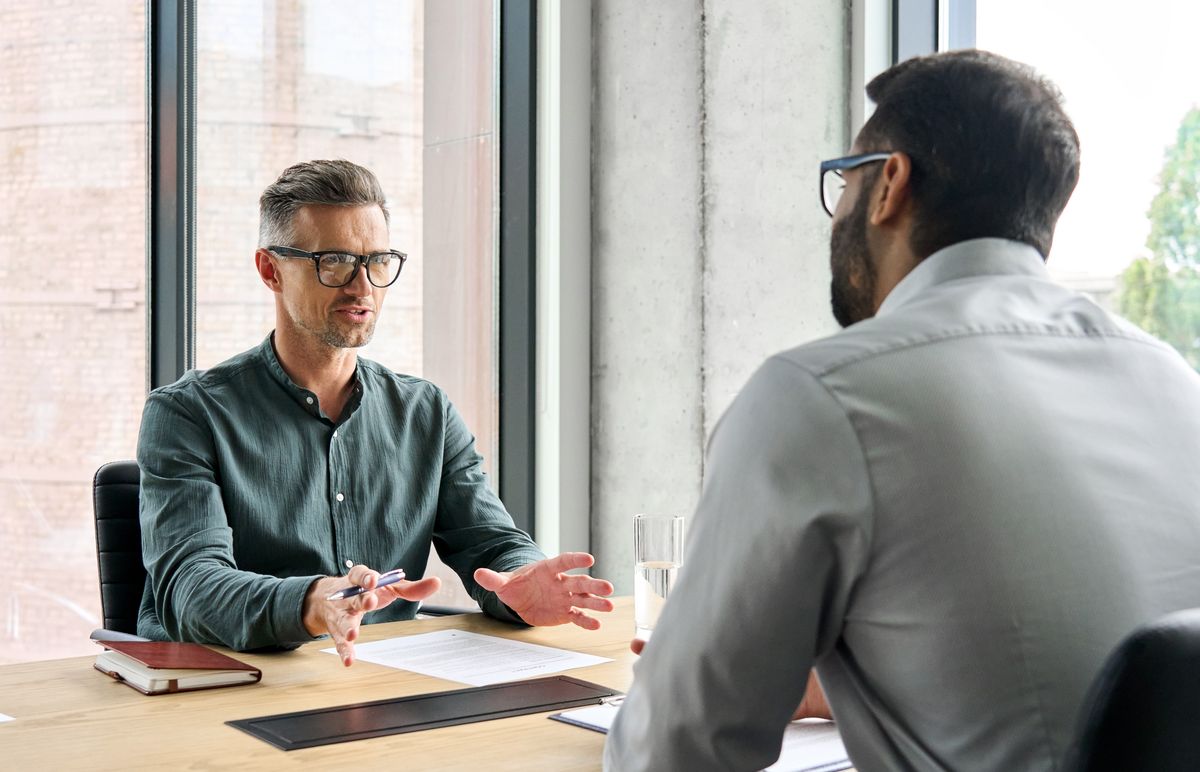 Two business leaders negotiating at a meeting