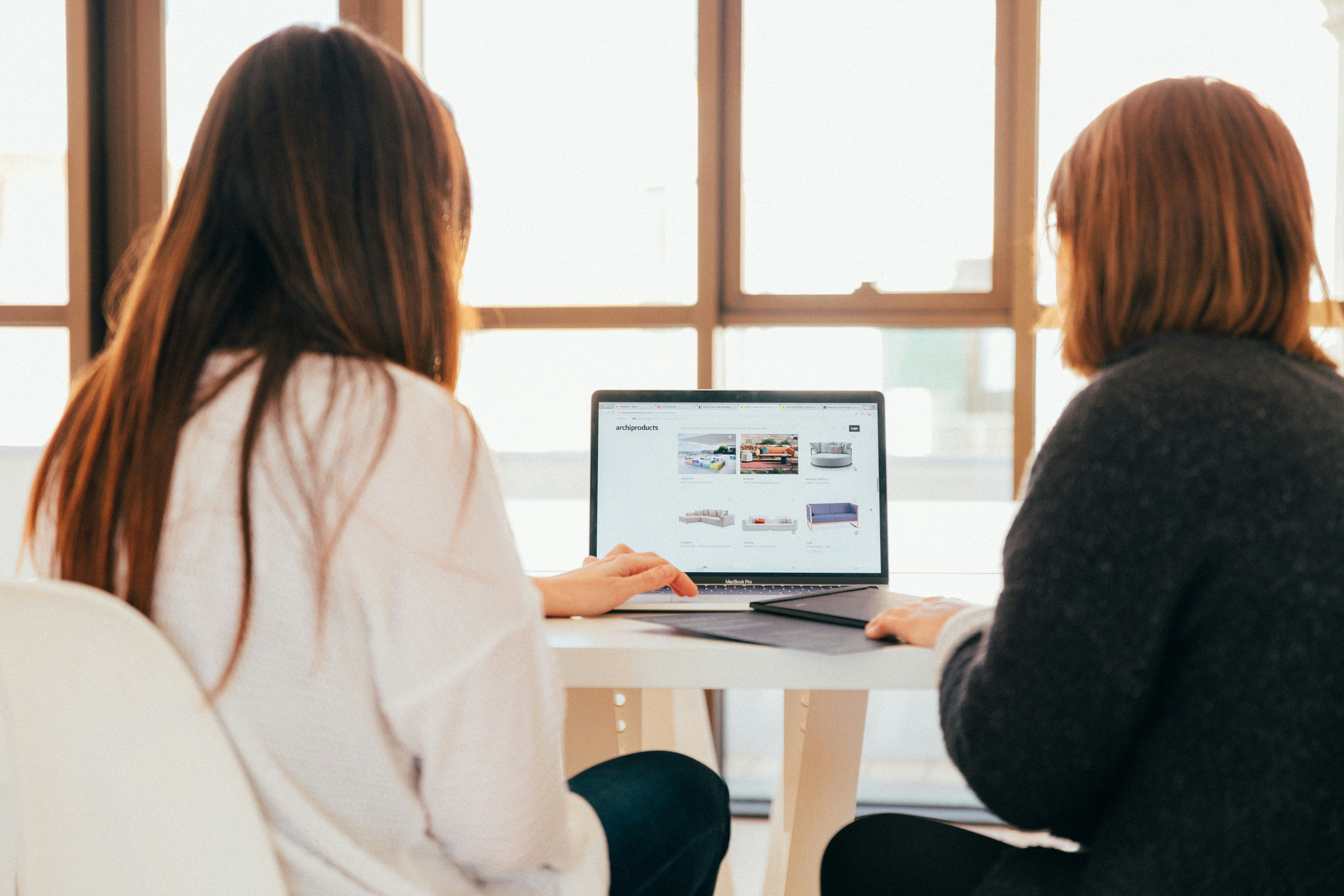 Two women honing their website copy