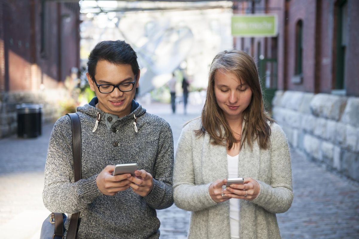 Two young people with smart phones