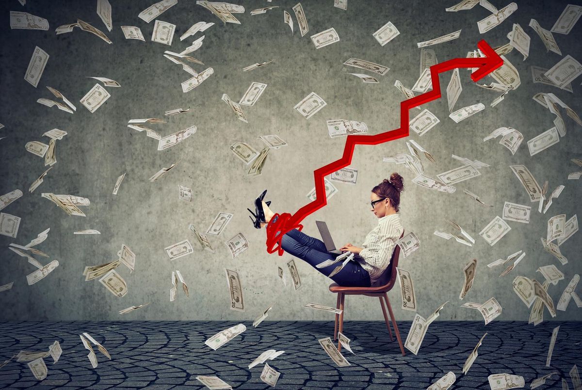 Woman among flying money with growing arrow
